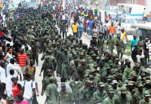 Former Haitian soldiers march during a M