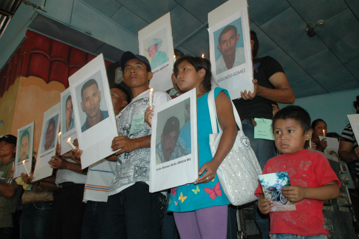 people holding pics of victims photo 1